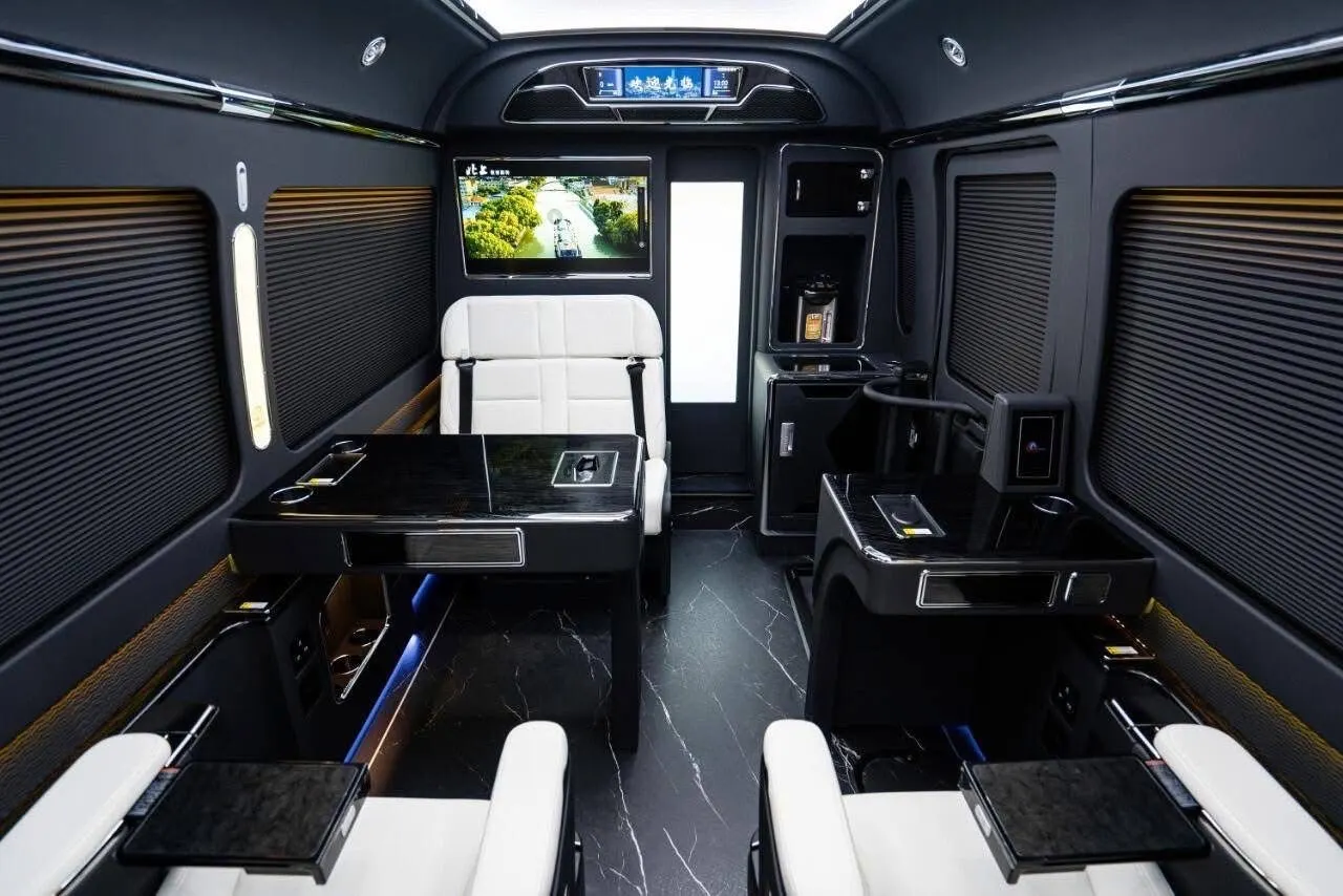 Executive minibus interior with central screen and ambient floor lighting